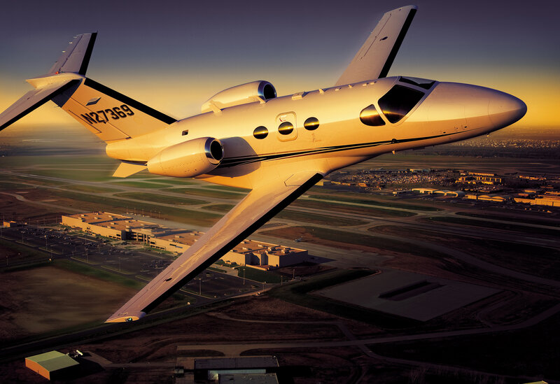 private jet flying over airport