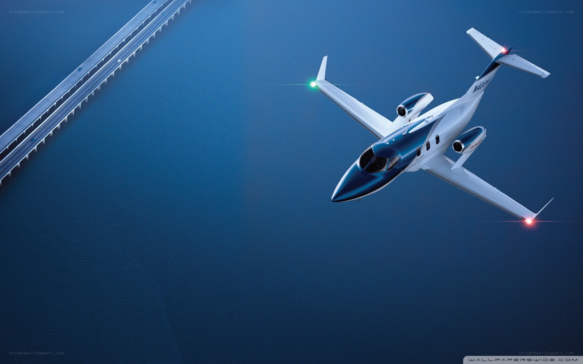 private jet flying over bridge