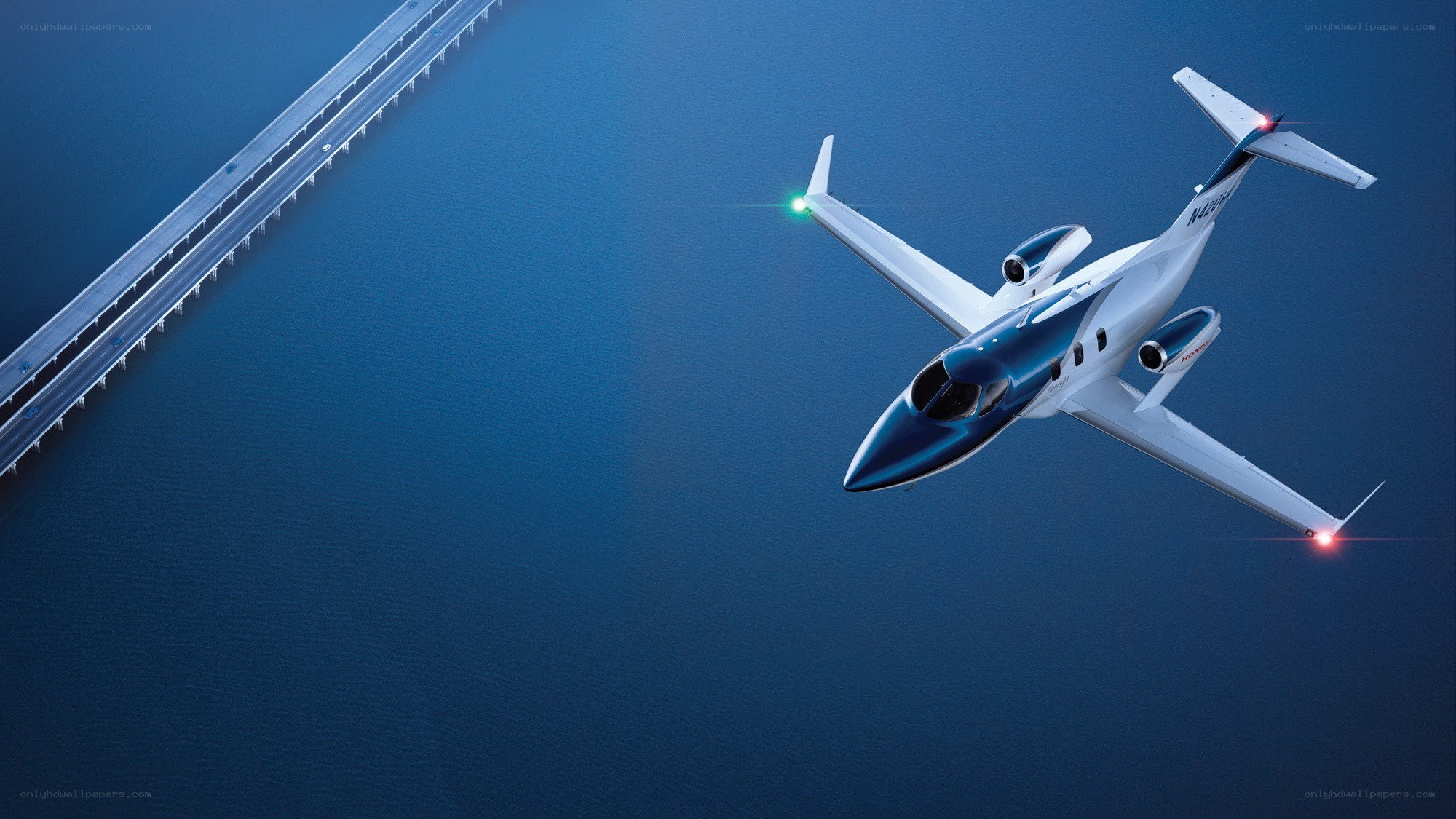private jet flying over bridge