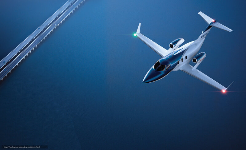 private jet flying over bridge