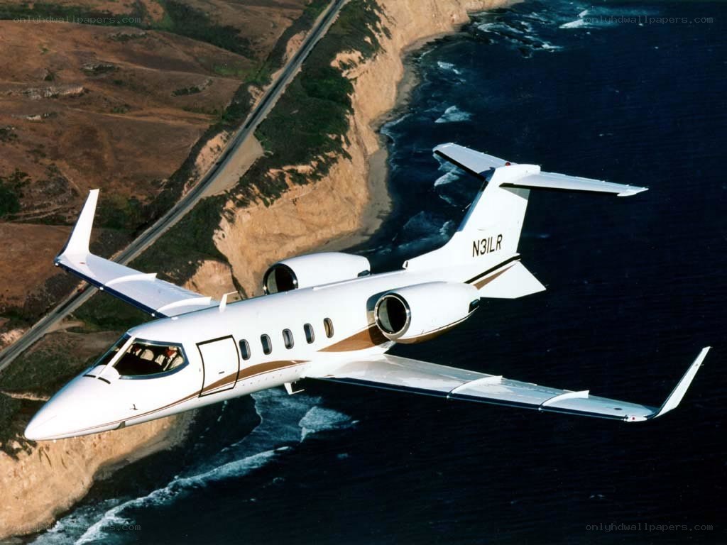 private jet flying over coastline