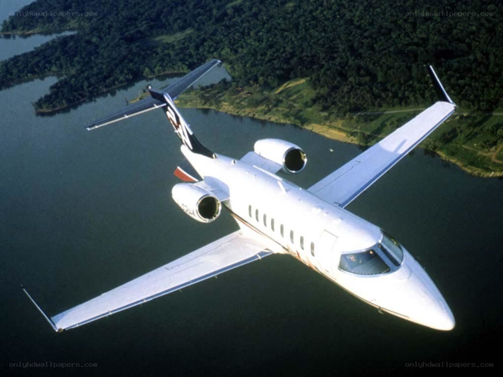 private jet flying over lake