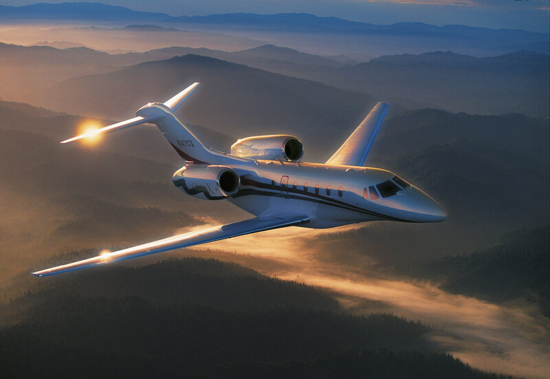 Private jet flying over mountains