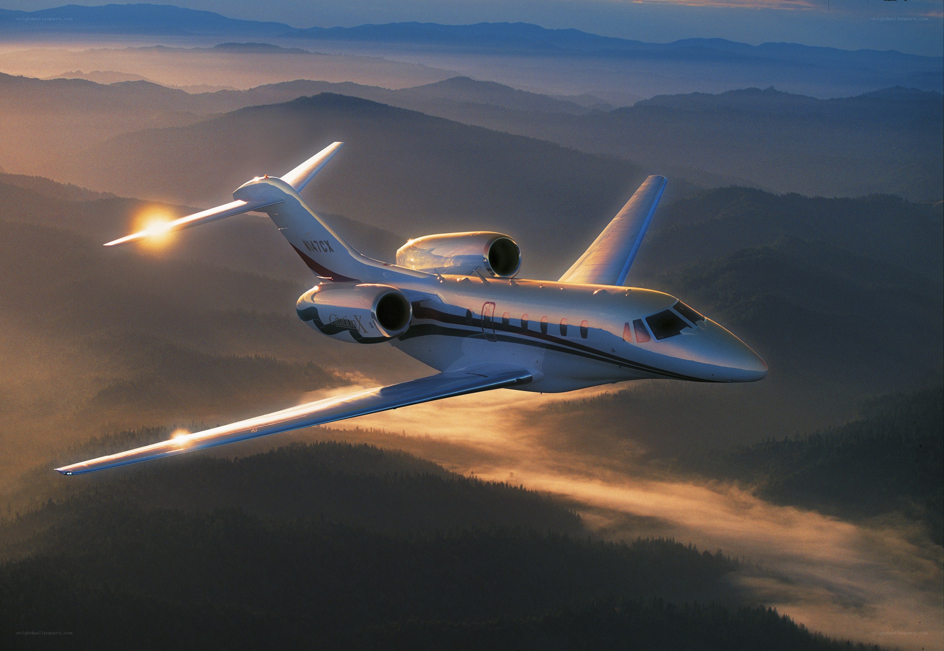 Private jet flying over mountains