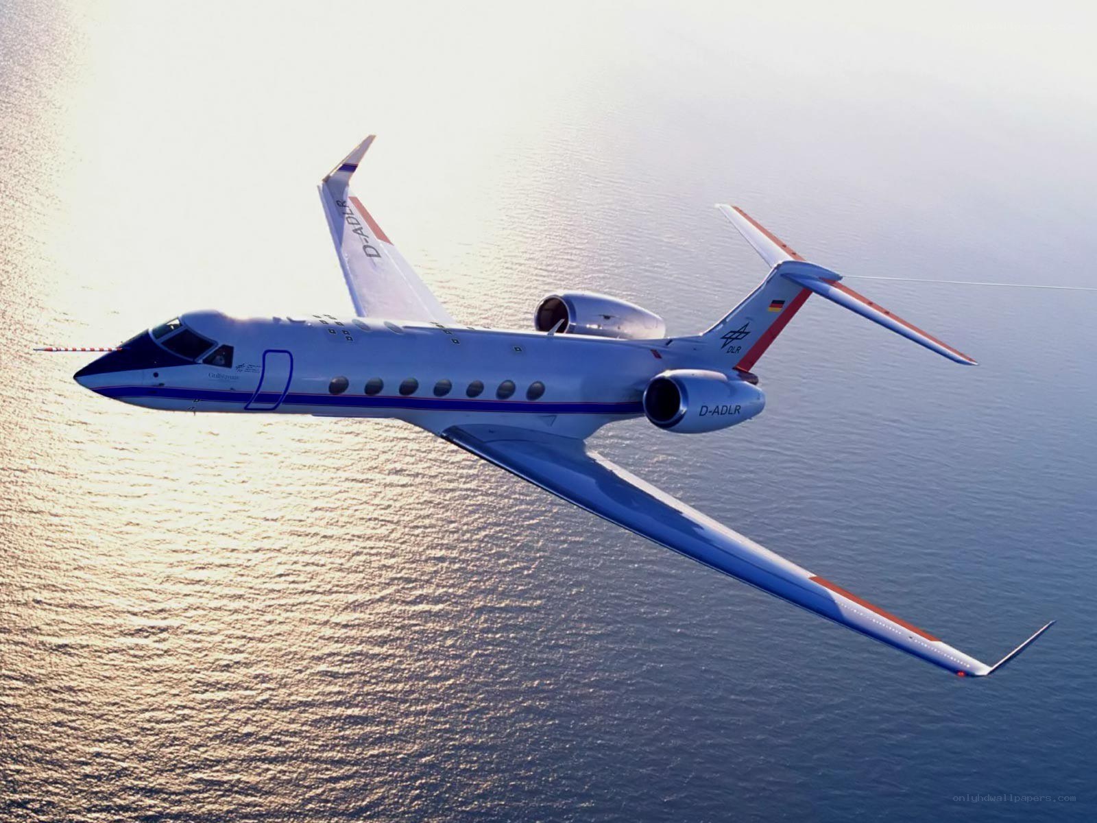 Private jet flying over ocean