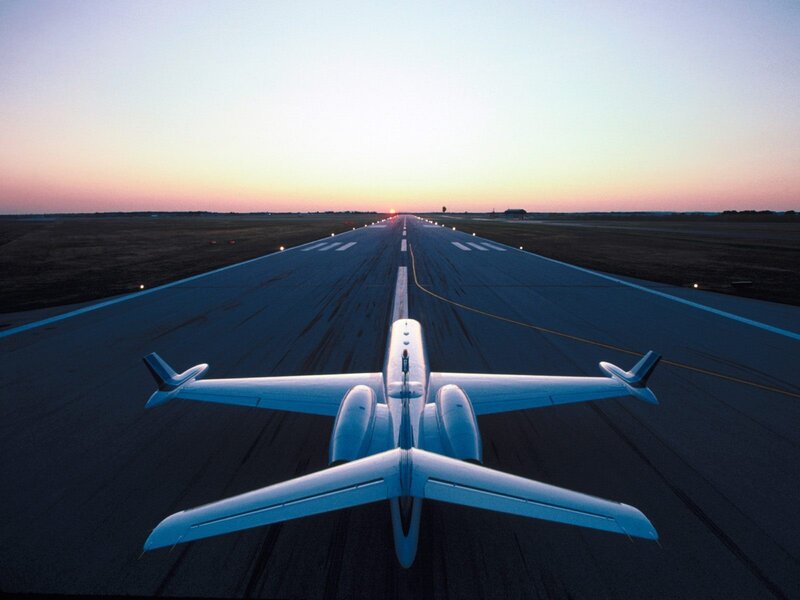 Private jet on runway at dusk