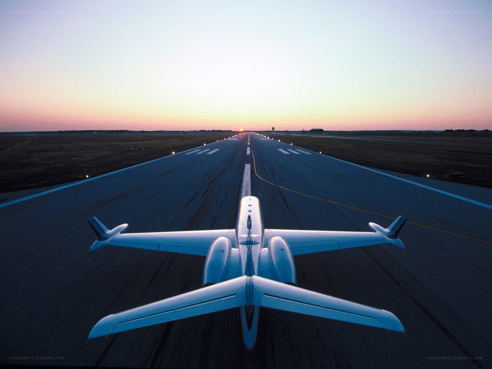 Private jet on runway at dusk