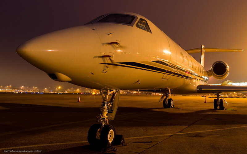 Private jet on tarmac at night