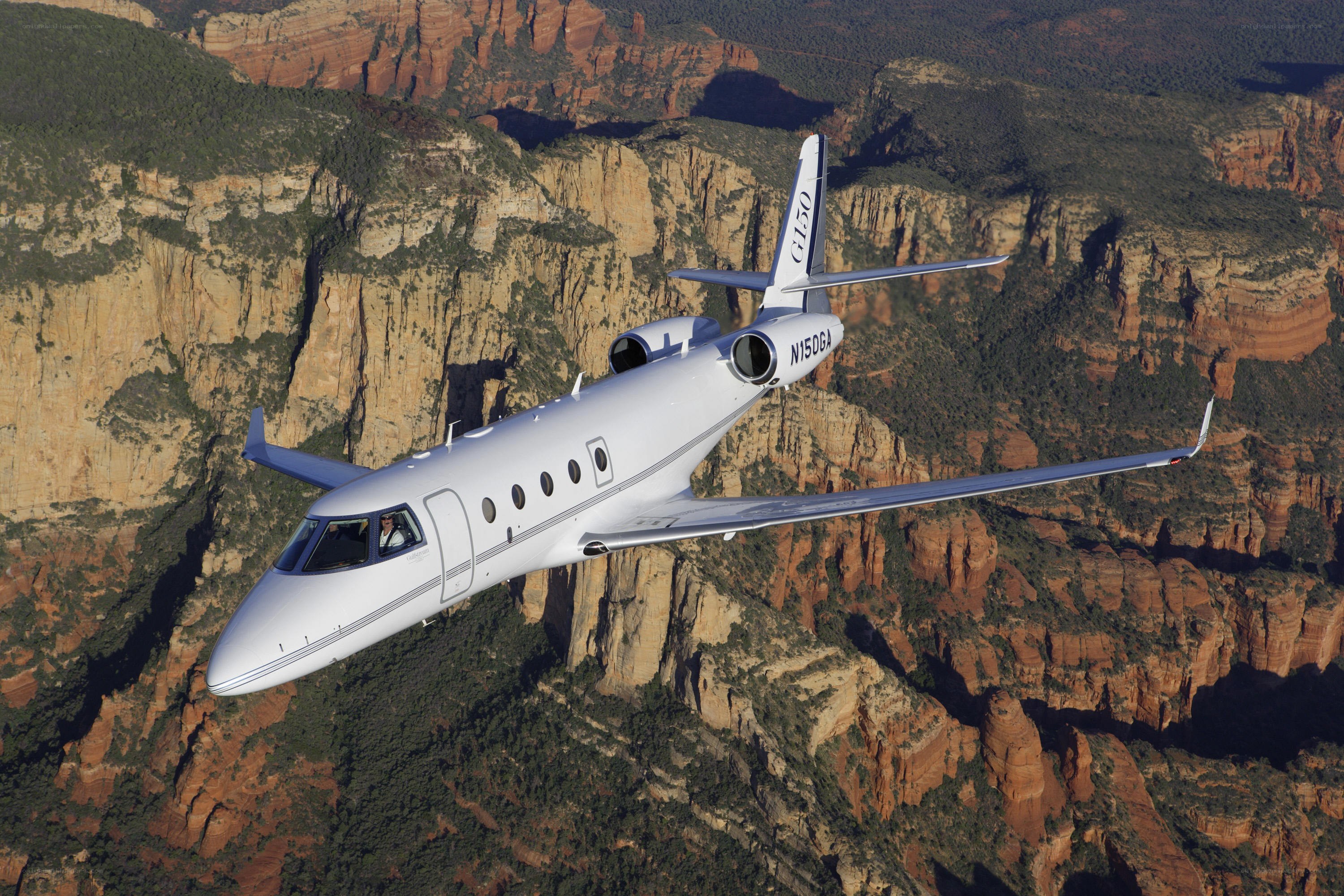 private jet over canyon