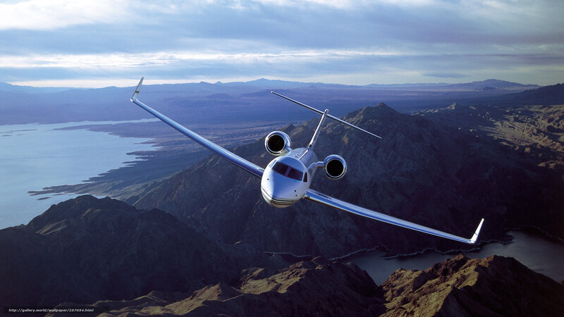 Private jet over mountains