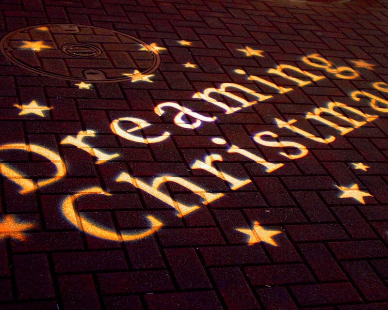 projected christmas message on pavement