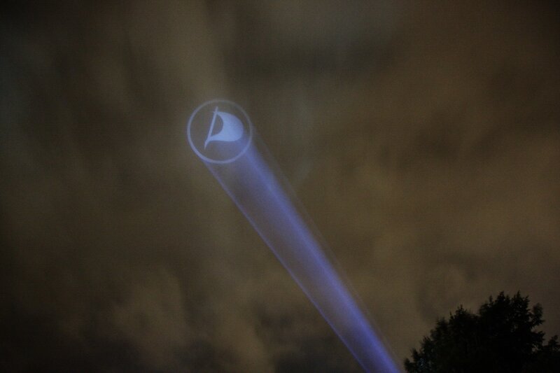 projected logo in night sky