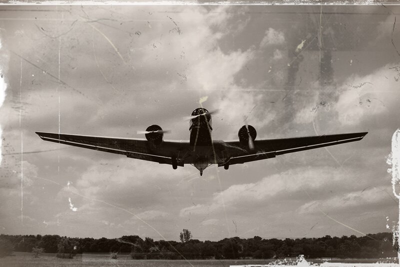 Propeller Airplane in Flight — Black