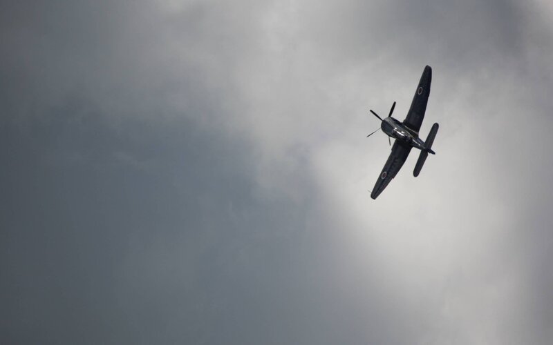 Propeller Airplane in Flight — Gray, Dramatic