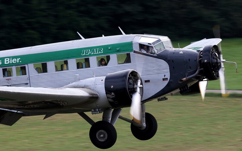 Propeller Airplane in Flight — Green, Dynamic, Afternoon