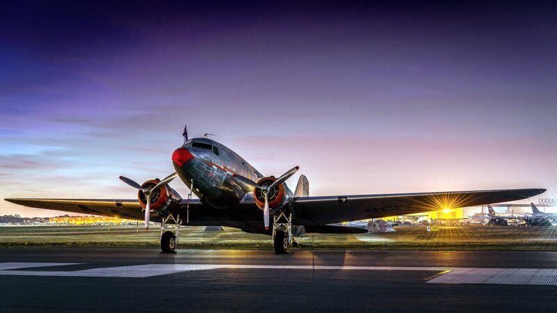 Propeller Airplane on Runway — Purple, Dramatic