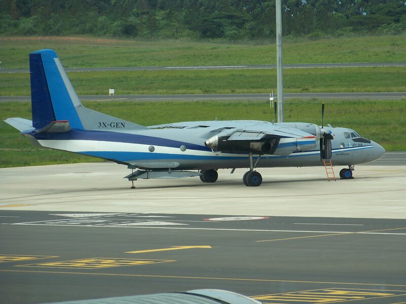 Propeller Airplane on Tarmac — Gray, Neutral, Afternoon, Photograph, Ladder