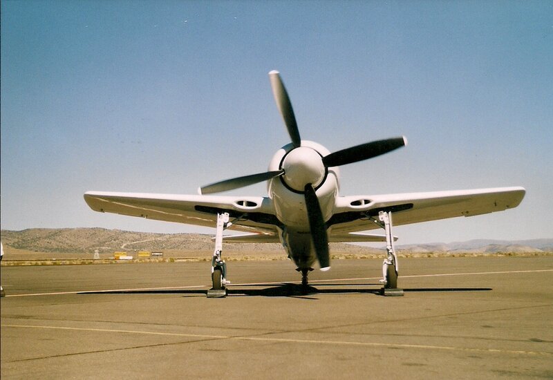 Propeller Airplane on Tarmac — White, Calm, Afternoon