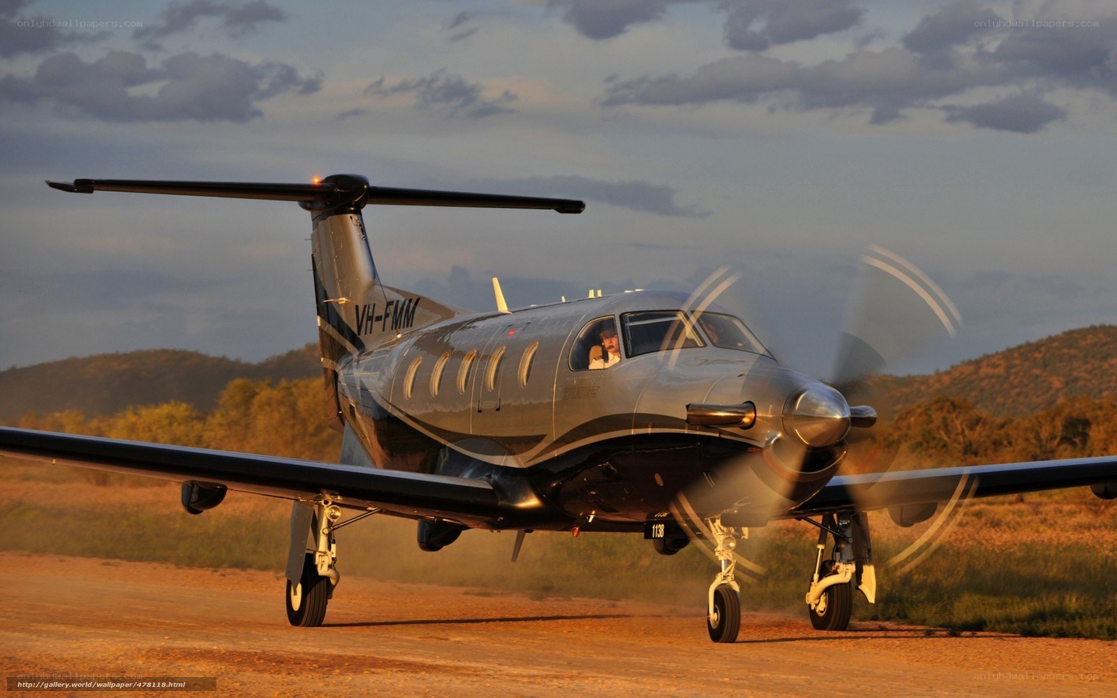 Propeller plane on dirt runway