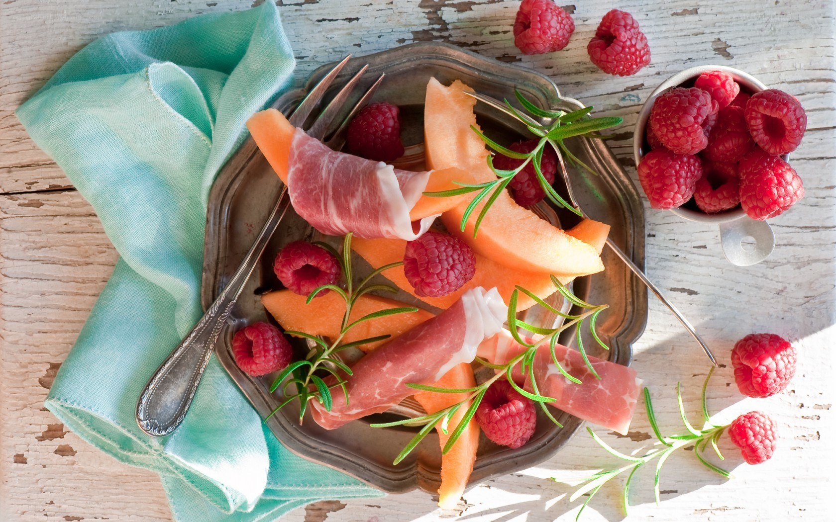 Prosciutto with melon and raspberries