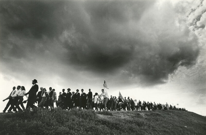 Protest march under stormy sky