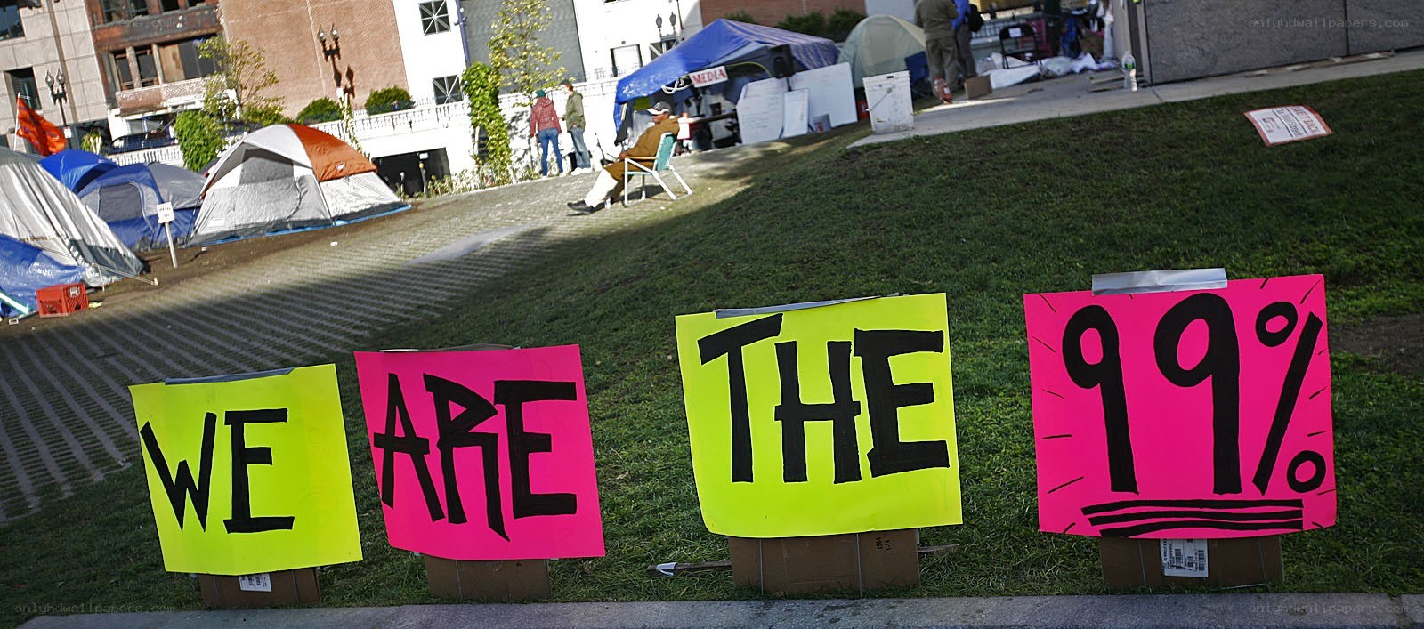 Protest signs reading 'WE ARE THE 99%'