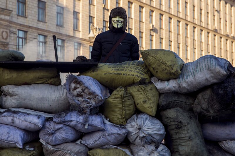 Protester behind sandbag barricade