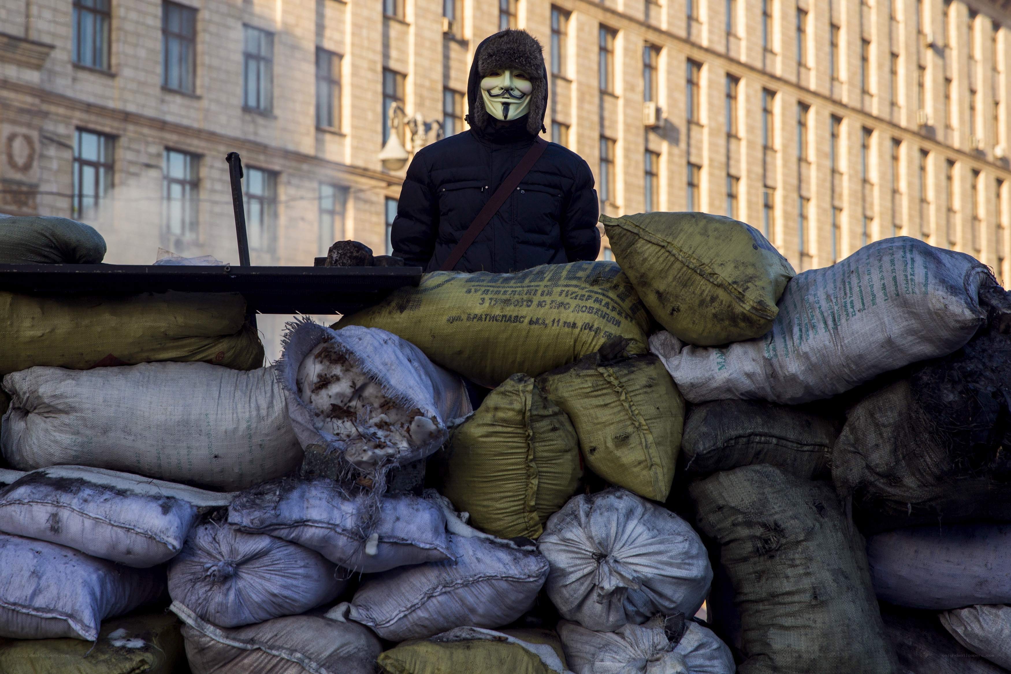 Protester behind sandbag barricade