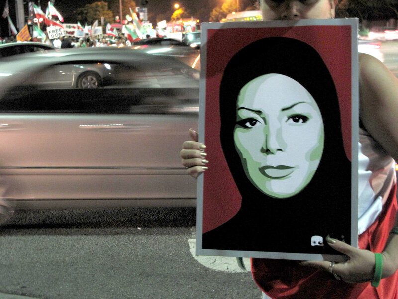 Protester holding portrait at night