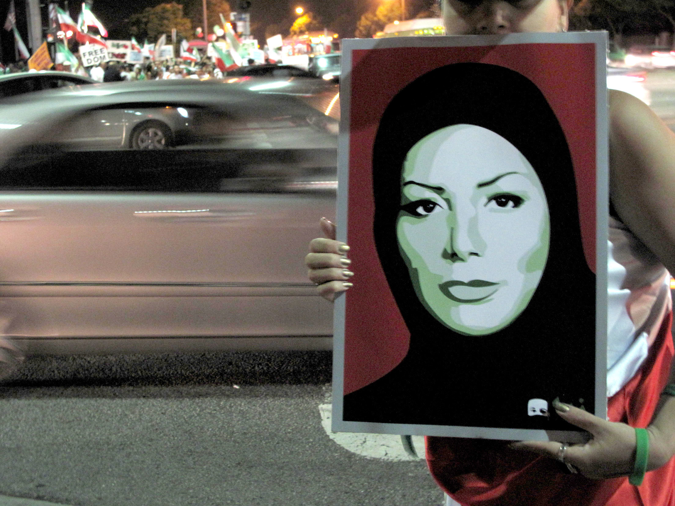 Protester holding portrait at night