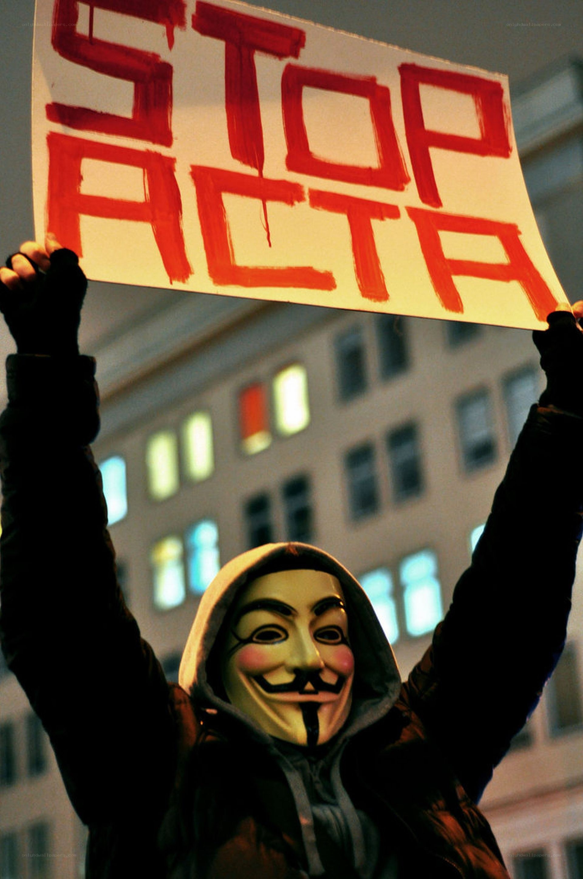 Protester holding stop acta sign