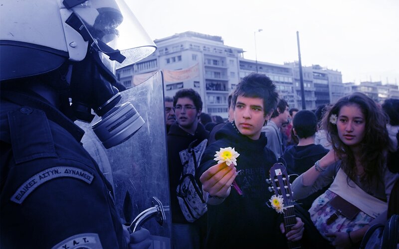Protester offers flower to police