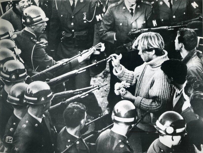 Protester offers flowers to soldiers