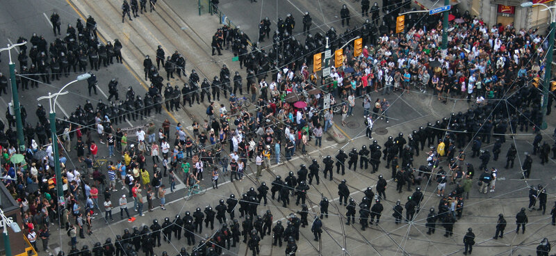 Protesters facing police at intersection