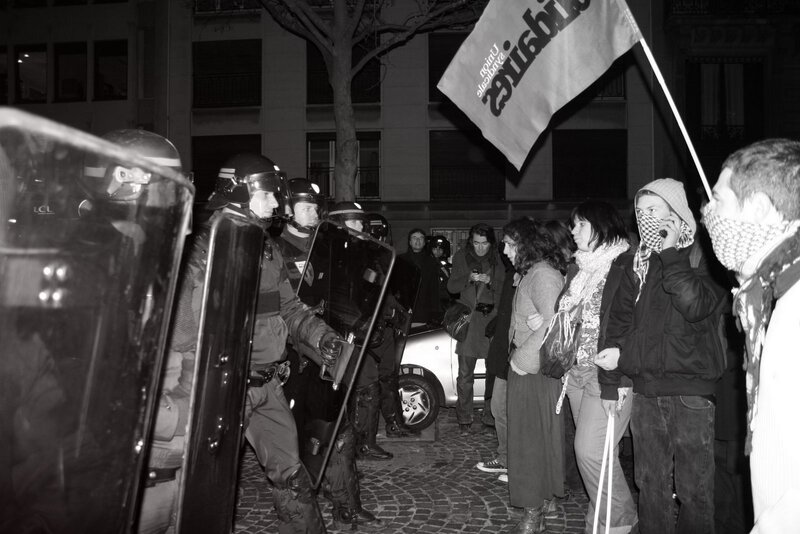 Protesters facing riot police