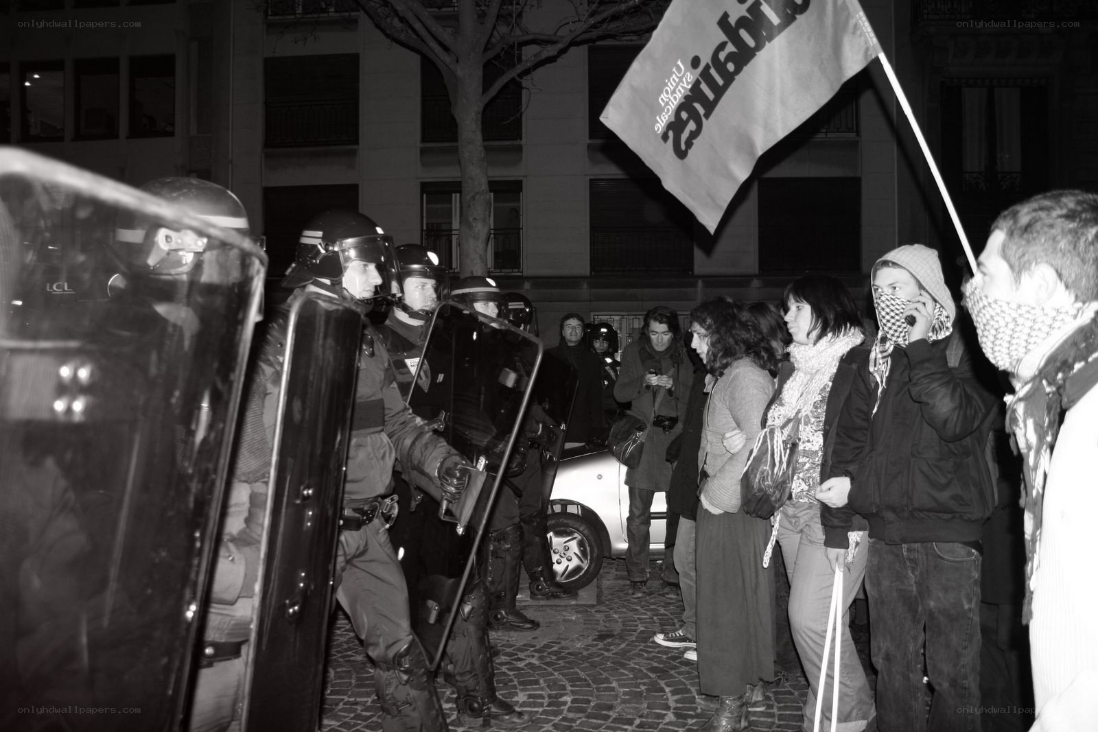 Protesters facing riot police