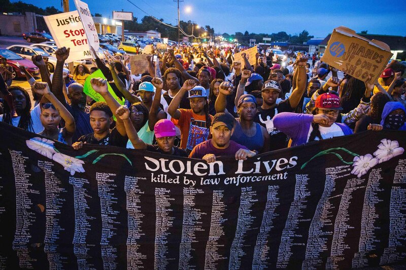 Protesters hold banner of stolen lives