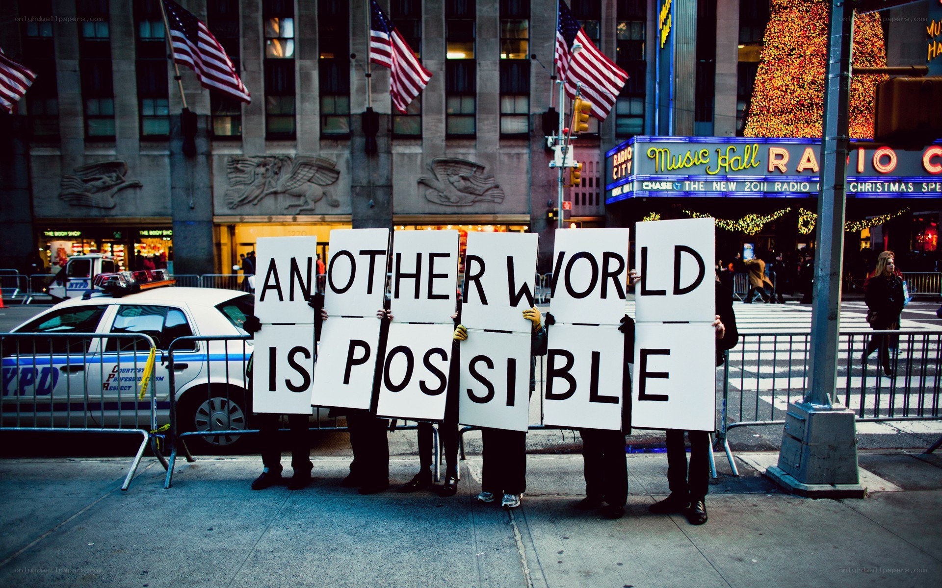 Protesters hold signs reading 'Another World Is Possible'