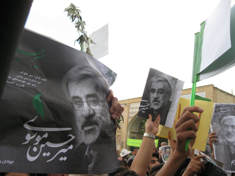 Protesters holding portraits