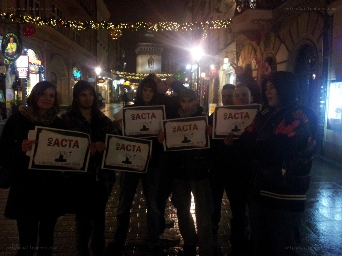 Protesters holding signs at night