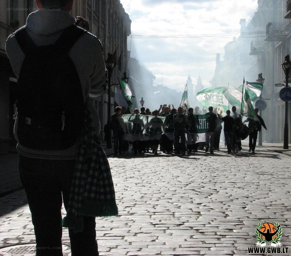 Protesters with green flags on cobblestone street