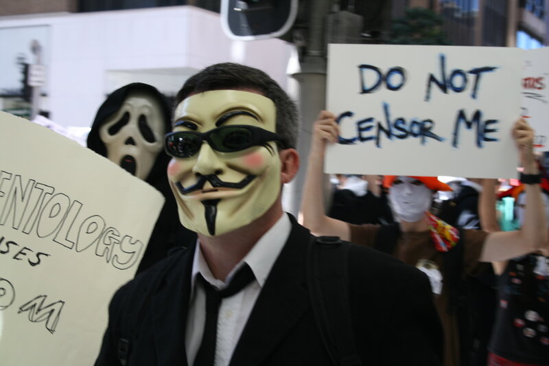 Protesters with masks and signs