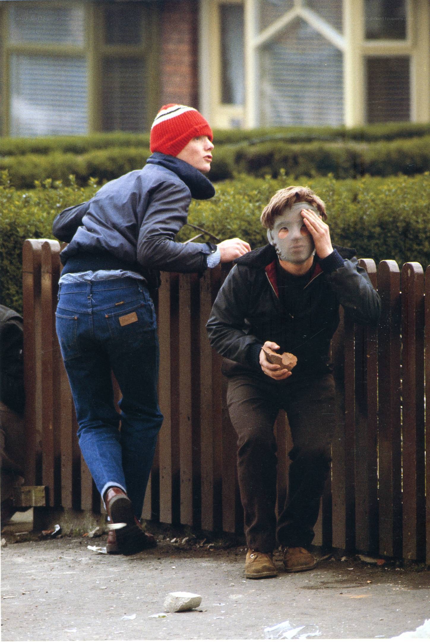 Protesters with masks and stones