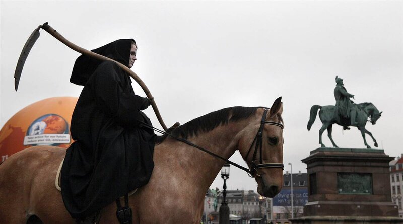 Protestor dressed as death on horseback