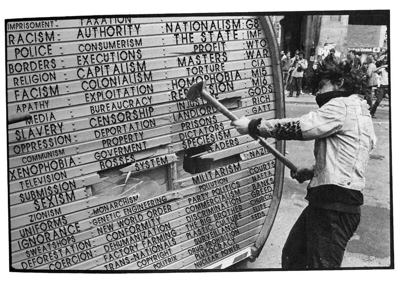 Protestor smashing anti-system shield