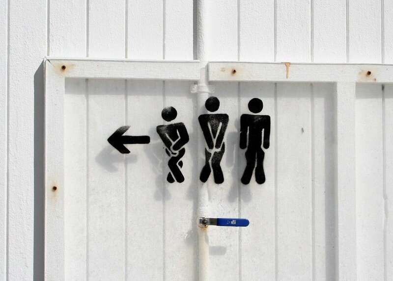 public restroom sign on white door