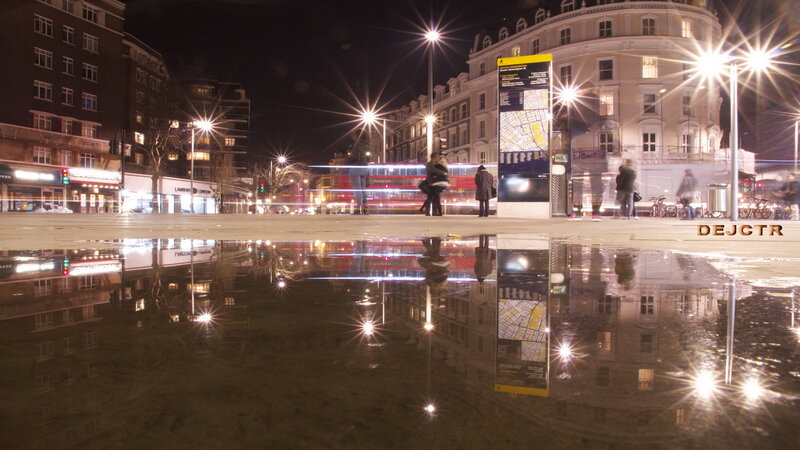 Puddle Reflecting City Lights