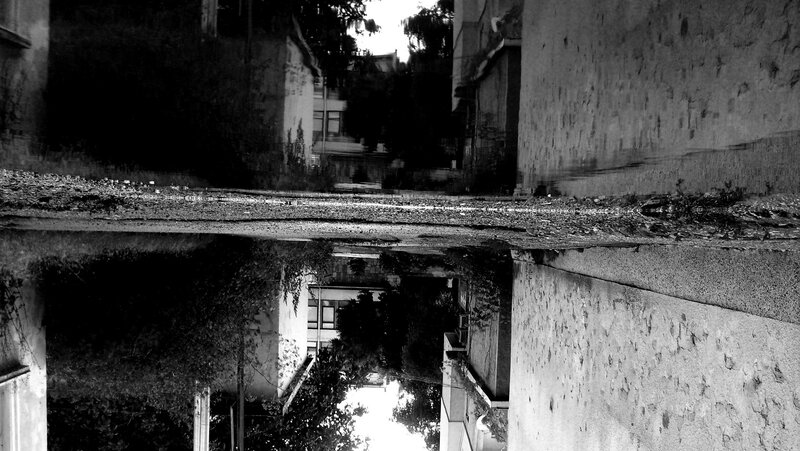 Puddle reflection of alleyway