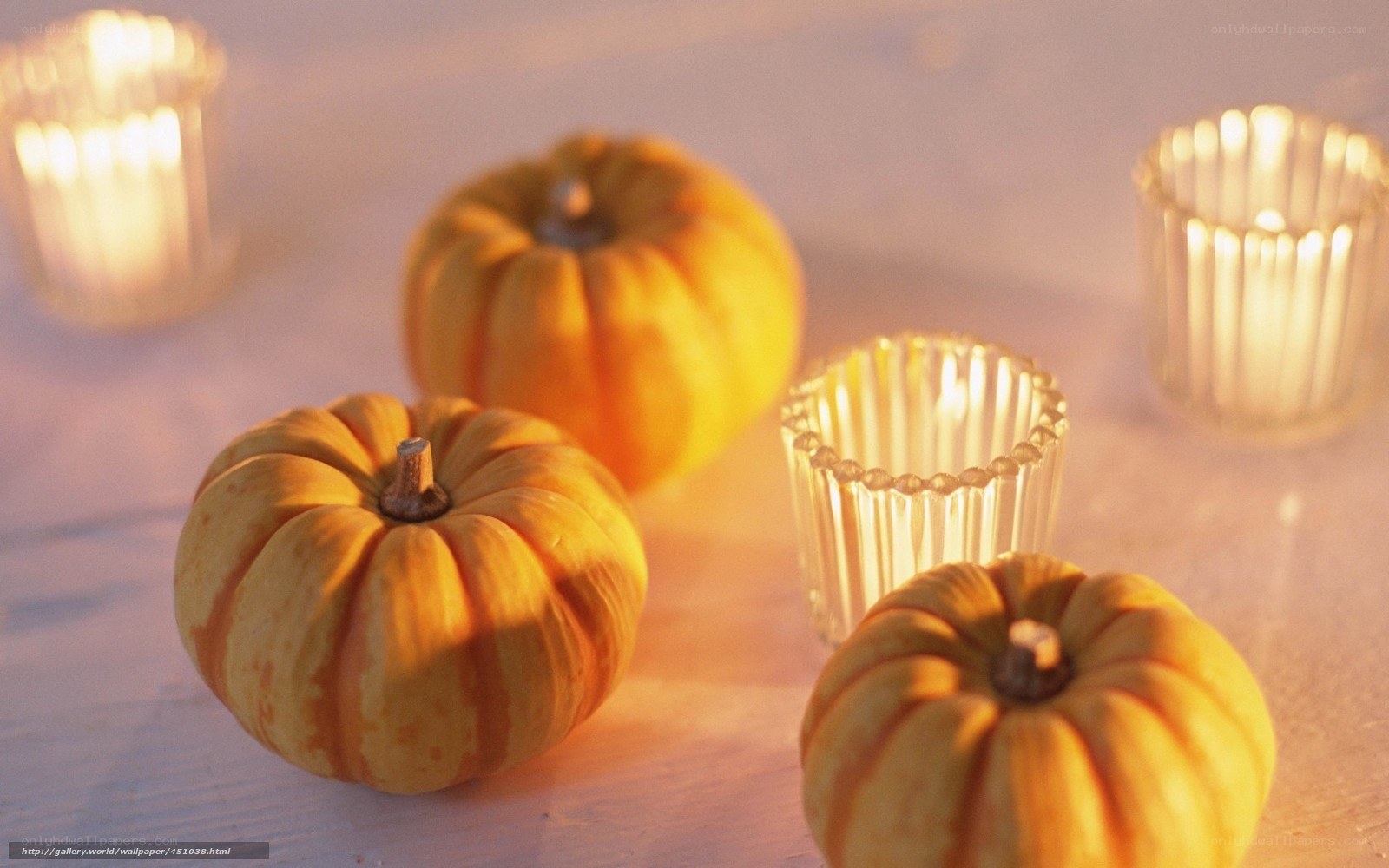 Pumpkins and candles on table