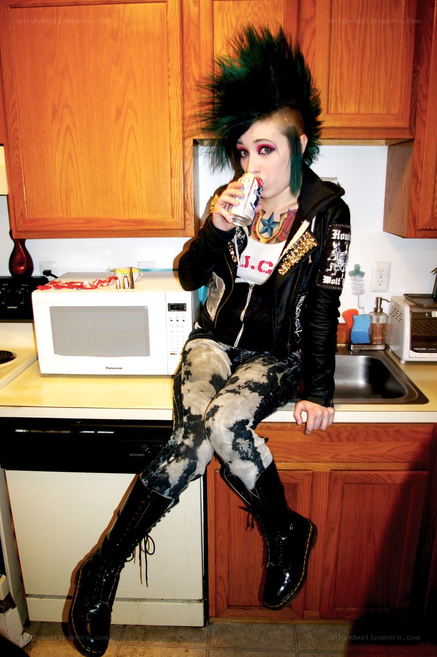 Punk person drinking in kitchen